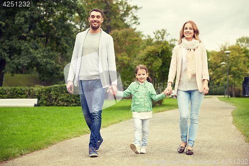 Image of happy family walking in summer park