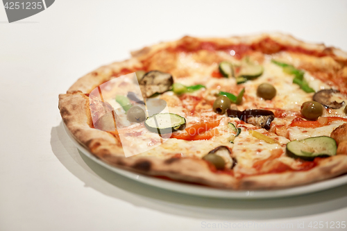 Image of close up of pizza on plate at pizzeria