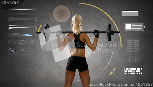 Image of sporty young woman flexing muscles with barbell