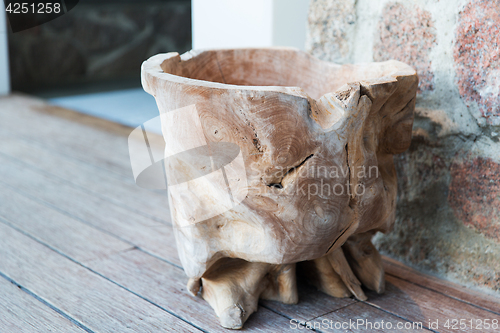 Image of outdoor wooden bowl or vase on terrace floor