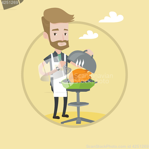 Image of Man cooking chicken on barbecue grill.