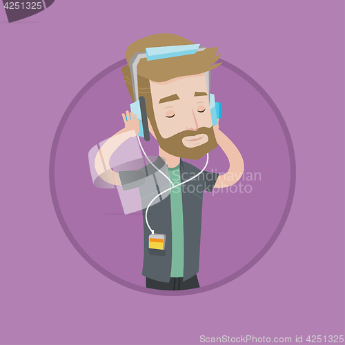 Image of Young man in headphones listening to music.