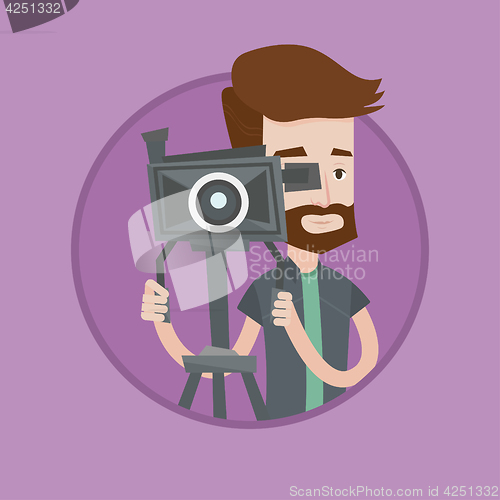 Image of Cameraman with movie camera on tripod.