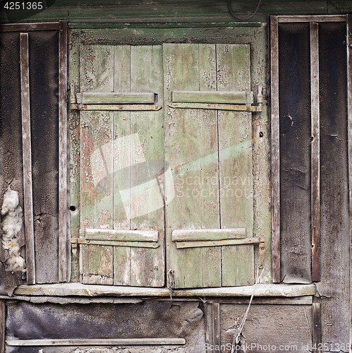 Image of wall with boarded up window