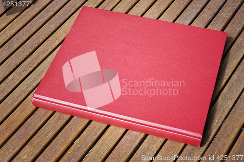 Image of Red book on the outdoor table at coffee shop