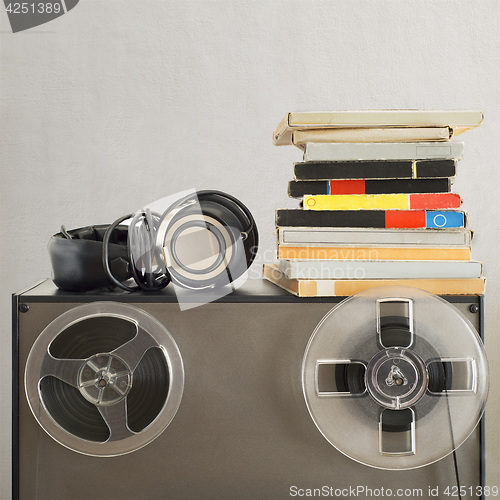 Image of Vintage magnetic audio reels and headphones on the analog tape recorder