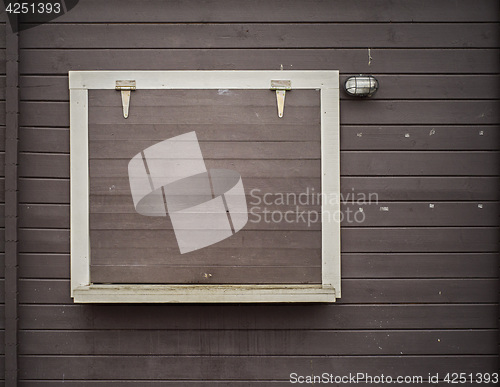 Image of White frame on the grunge wooden plank wall