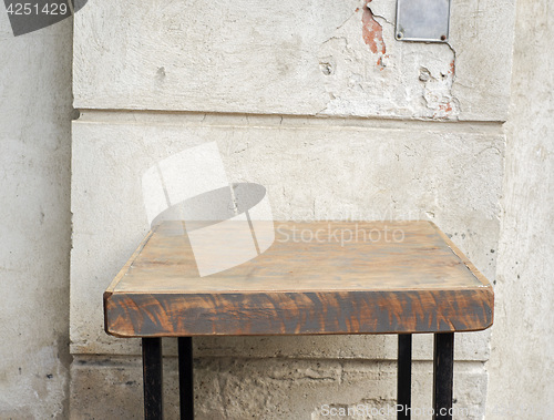 Image of outdoor table near the stucco grunge wall