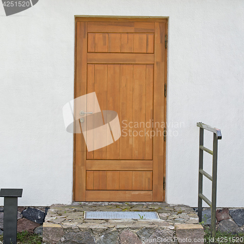 Image of stucco wall with brown door