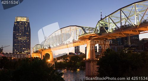 Image of People Walk Across Cumberland River Pedestrian Bridge Nashville 