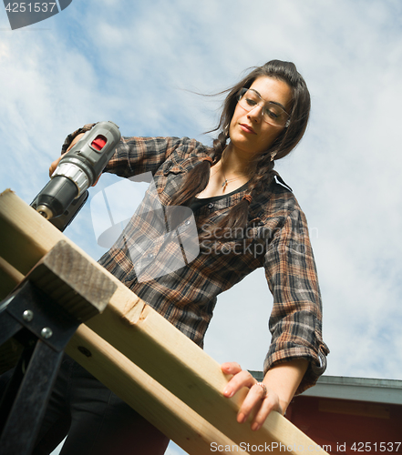 Image of Craftsperson Woman Uses Power Screwdriver Drilling Holes Wood