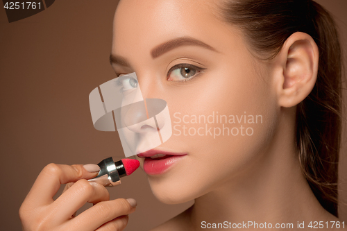 Image of Beautiful female lips with make-up and brush