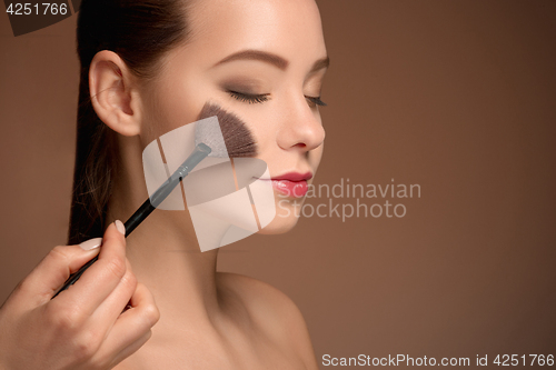 Image of Beauty Girl with Makeup Brush. Perfect Skin. Applying Makeup