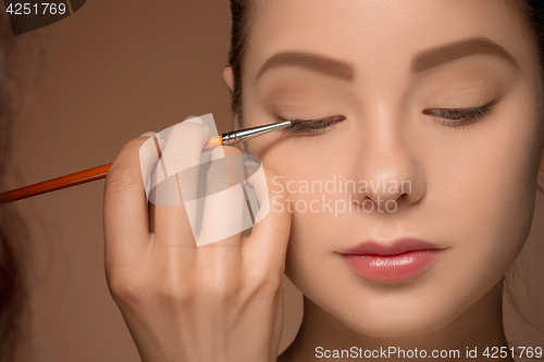 Image of Beautiful female eyes with make-up and brush