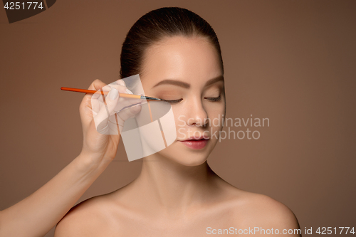 Image of Beautiful female eyes with make-up and brush