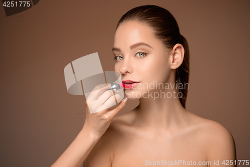 Image of Beautiful female lips with make-up and brush