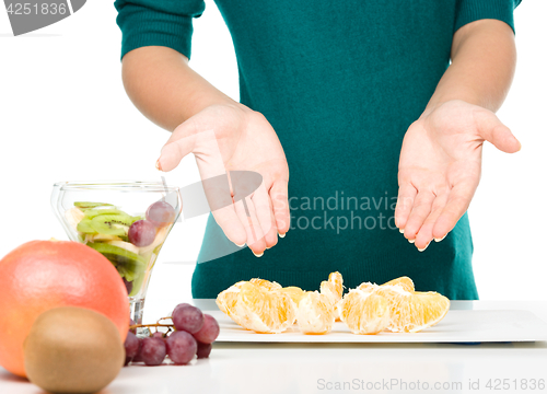 Image of Cook is making fruit dessert