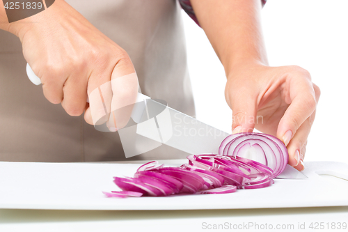 Image of Cook is chopping onion