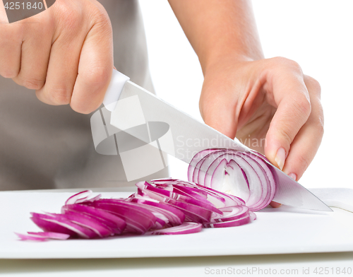 Image of Cook is chopping onion