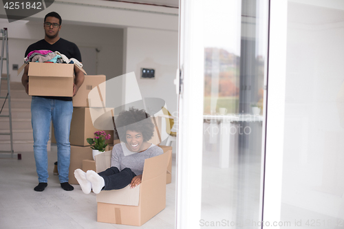 Image of African American couple  playing with packing material