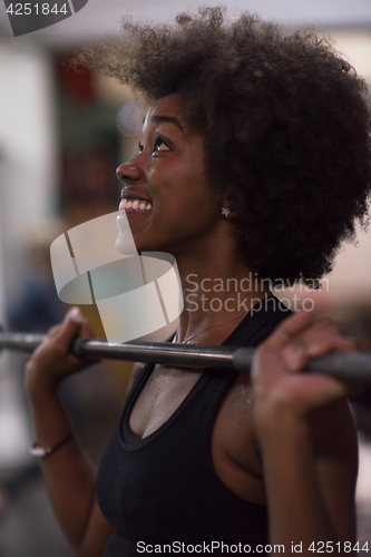 Image of black woman lifting empty bar