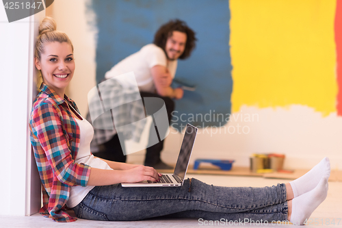 Image of Happy couple doing home renovations