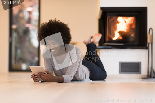 Image of black women using tablet computer on the floor