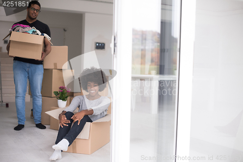 Image of African American couple  playing with packing material