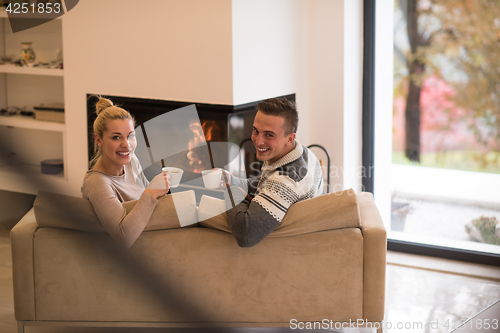 Image of Young couple  in front of fireplace