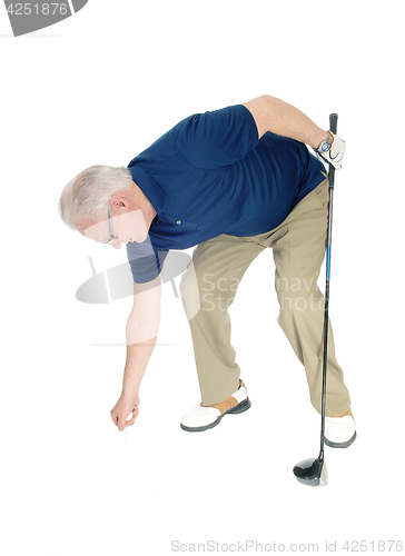 Image of Senior man pleasing his golf ball.