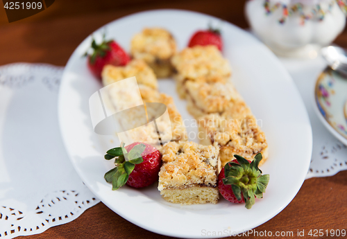 Image of pieces of cake or pie and strawberries on plate