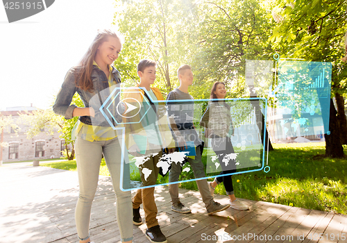 Image of group of happy teenage students walking outdoors