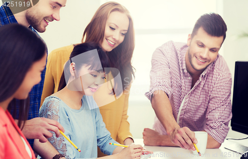 Image of happy creative team or students working at office