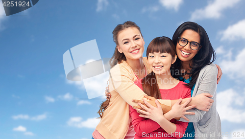 Image of international group of happy women hugging