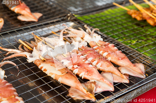 Image of squids on grill at street market