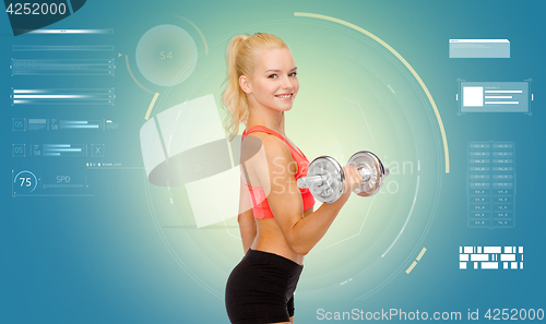 Image of happy young sporty woman exercising with dumbbell