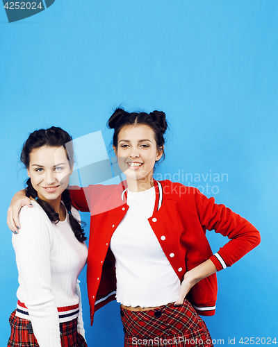 Image of best friends teenage school girls together having fun, posing emotional on blue background, besties happy smiling, lifestyle people concept 