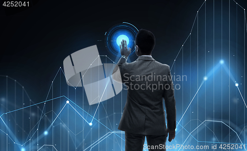 Image of businessman working with virtual chart projection