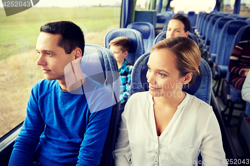 Image of happy couple or passengers in travel bus