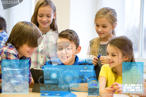 Image of group of school kids with tablet pc in classroom