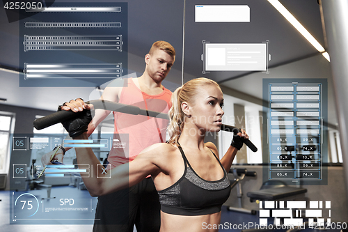 Image of man and woman flexing muscles on gym machine