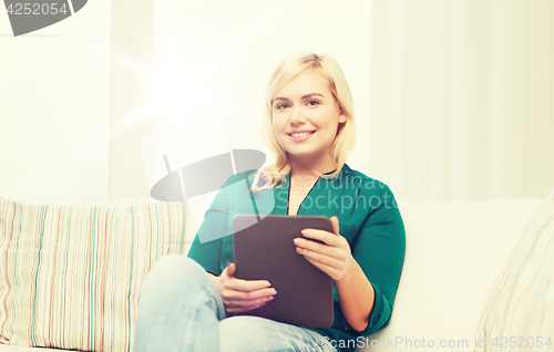 Image of smiling woman with tablet pc at home