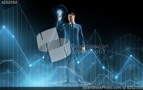 Image of businessman in suit touching virtual graph