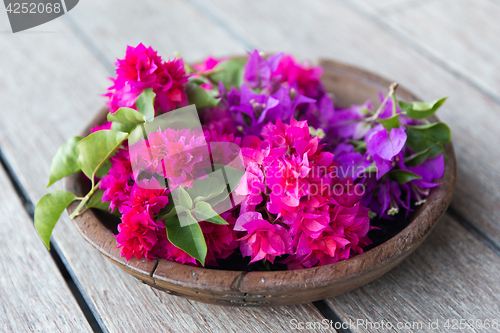 Image of beautiful exotic flowers in wooden bowl