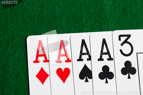 Image of poker hand of playing cards on green casino cloth