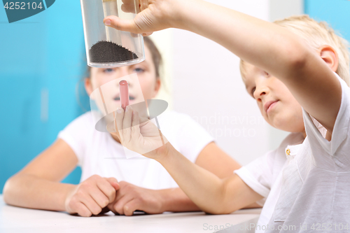 Image of Young explorer. Lesson physics. Physical experiment. The joy of discovery.