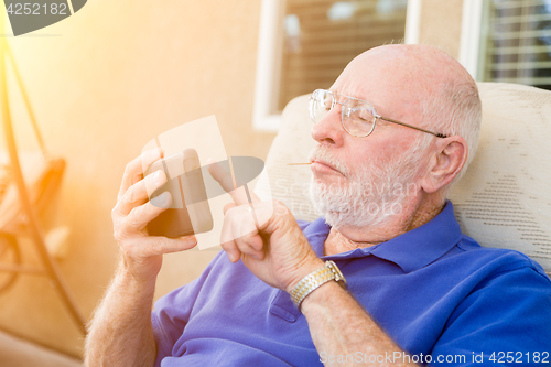 Image of Senior Adult Man Using Smart Cell Phone.