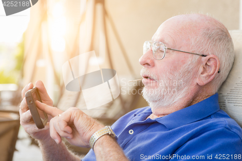 Image of Senior Adult Man Using Smart Cell Phone.