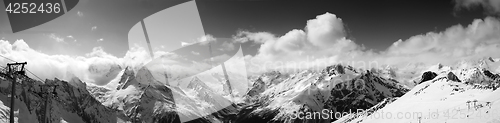 Image of Black and white panoramic view on ski slope and cloudy mountains