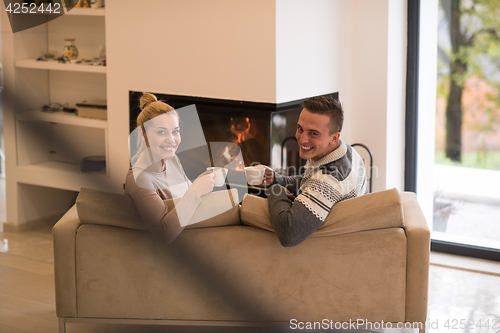 Image of Young couple  in front of fireplace